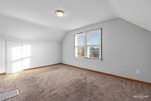 bonus room featuring vaulted ceiling and carpet flooring