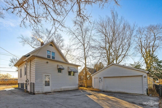 view of property exterior with a garage and an outdoor structure