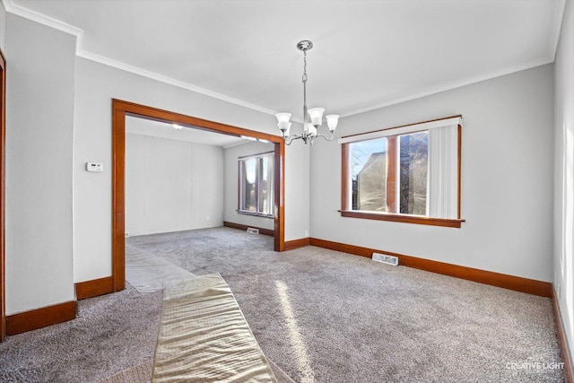 interior space featuring an inviting chandelier, ornamental molding, and carpet