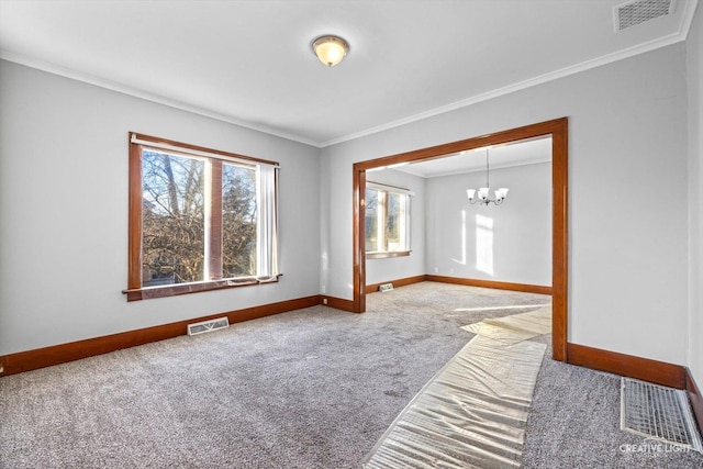 carpeted empty room with crown molding, plenty of natural light, and a chandelier