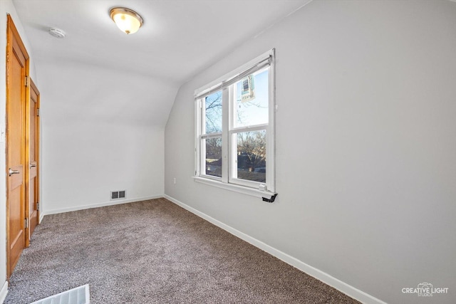 bonus room with vaulted ceiling and carpet flooring