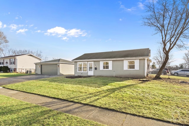 ranch-style house featuring a garage, an outbuilding, and a front yard