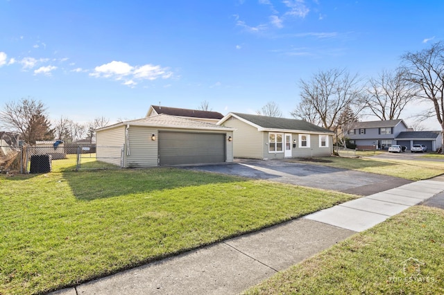 ranch-style house featuring a front lawn and a garage