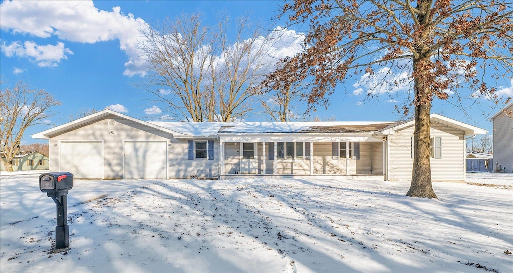 single story home with a porch and a garage