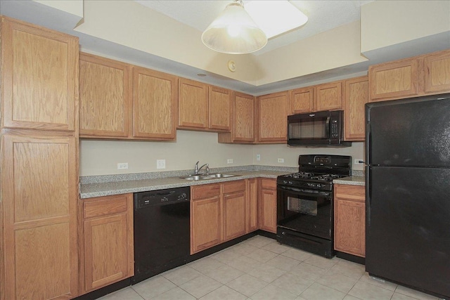 kitchen featuring light brown cabinets, sink, and black appliances