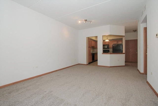 unfurnished living room featuring light carpet