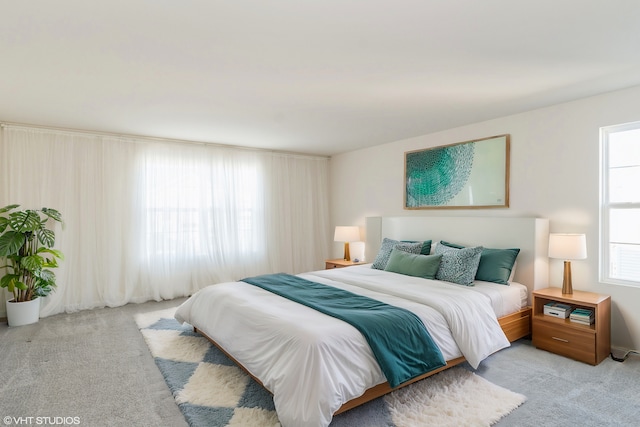 carpeted bedroom with multiple windows