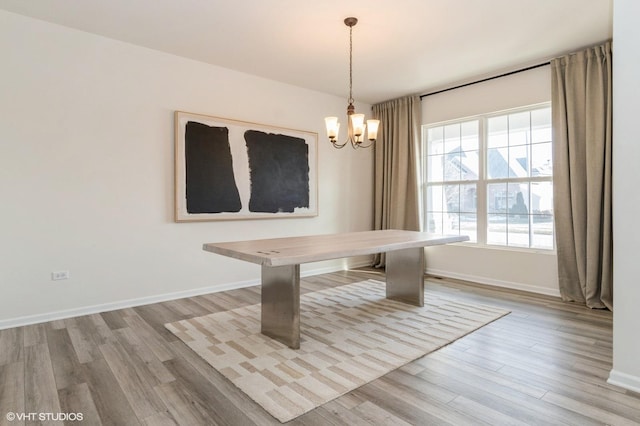 unfurnished dining area with a notable chandelier and light hardwood / wood-style floors