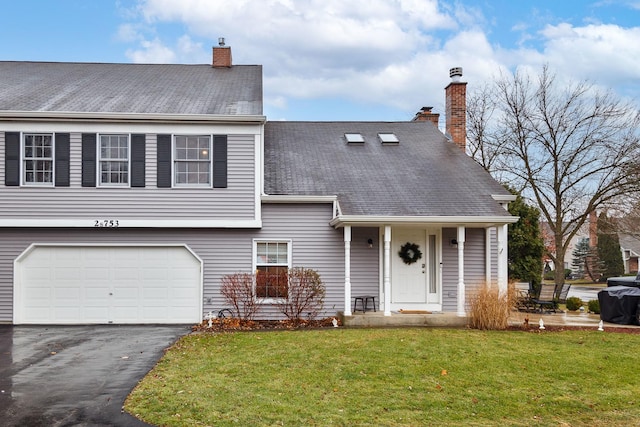 view of front of home featuring a garage and a front lawn