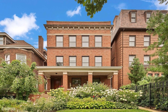 exterior space featuring brick siding and fence