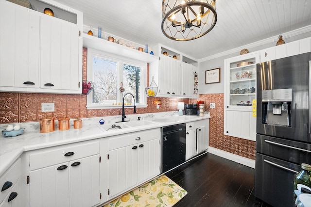 kitchen featuring stainless steel refrigerator with ice dispenser, sink, decorative light fixtures, black dishwasher, and white cabinets