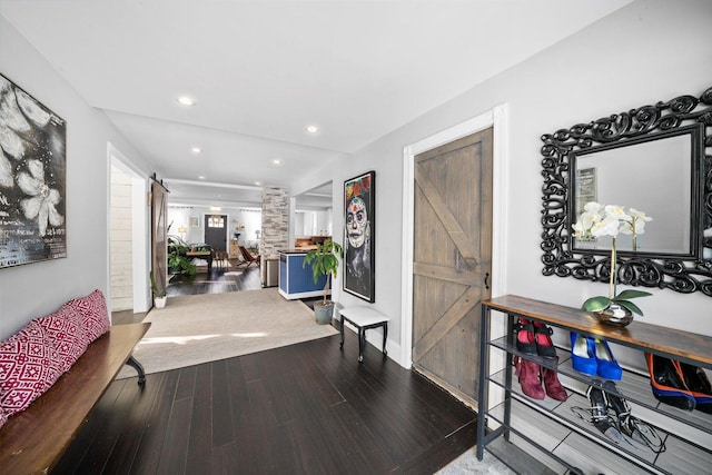 hallway featuring hardwood / wood-style flooring and a barn door