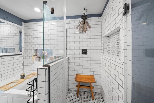 bathroom with tile walls, tile patterned flooring, and plus walk in shower