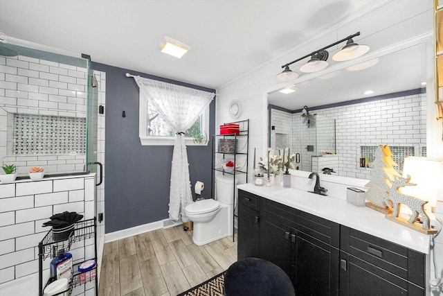 bathroom with vanity, a shower with shower door, and toilet