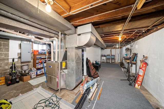 basement featuring electric panel and heating unit