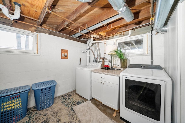 clothes washing area with washer and clothes dryer