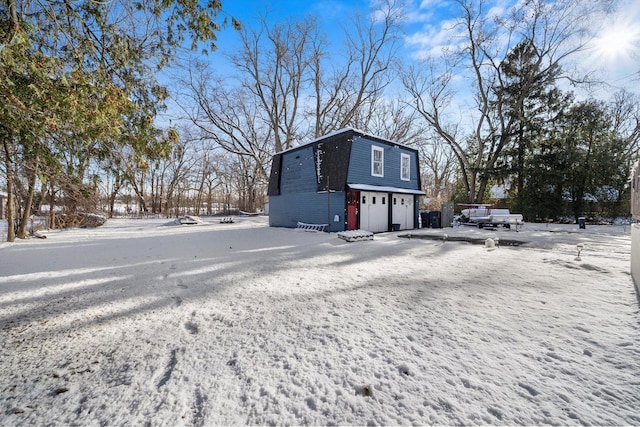 view of snow covered exterior with a garage