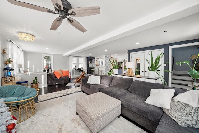 living room featuring ceiling fan and light hardwood / wood-style flooring