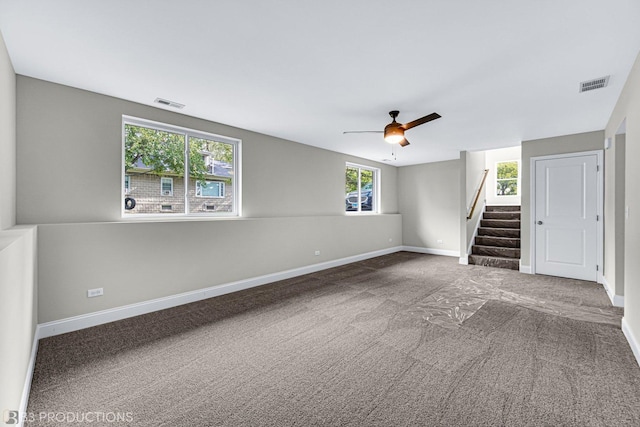 unfurnished living room with carpet flooring, ceiling fan, and plenty of natural light