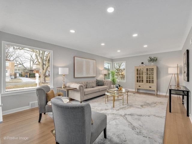 living room with plenty of natural light and light hardwood / wood-style floors