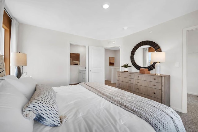 carpeted bedroom with ensuite bath