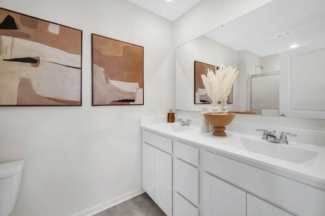 bathroom featuring vanity and toilet