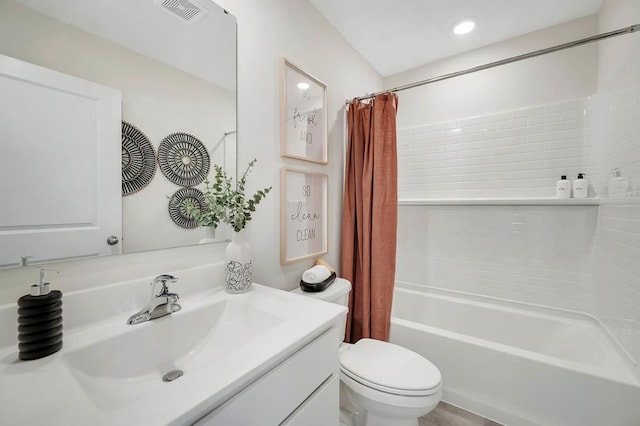 full bathroom featuring shower / bath combination with curtain, vanity, and toilet