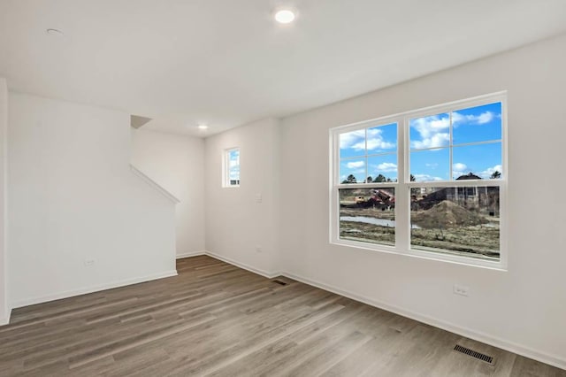 spare room with hardwood / wood-style floors