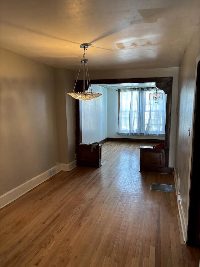 unfurnished dining area featuring hardwood / wood-style floors