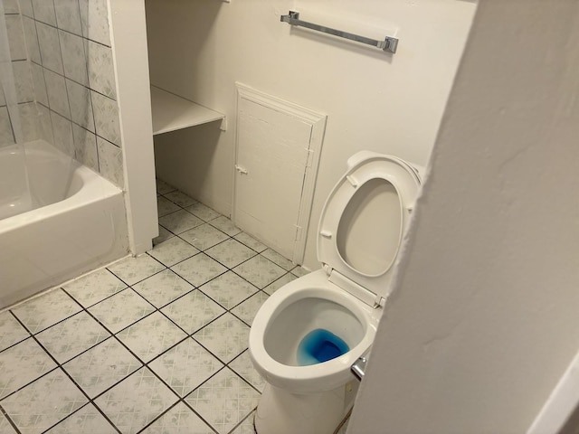 bathroom with tile patterned floors, shower / bath combination, and toilet