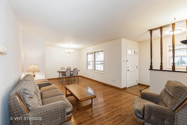 living room featuring a notable chandelier and hardwood / wood-style flooring