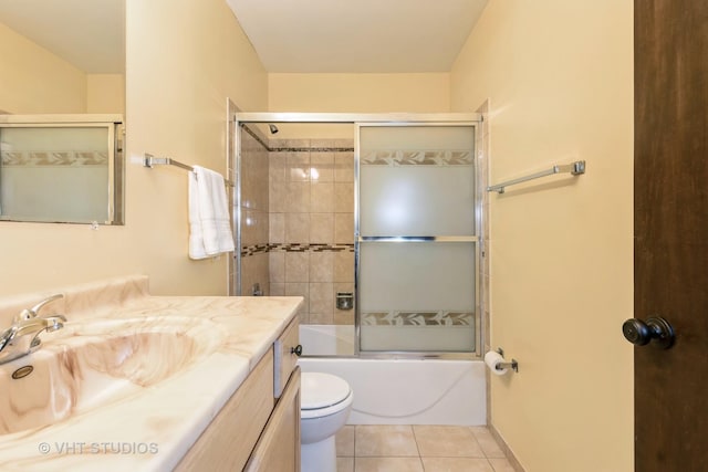 full bathroom featuring tile patterned flooring, vanity, toilet, and enclosed tub / shower combo