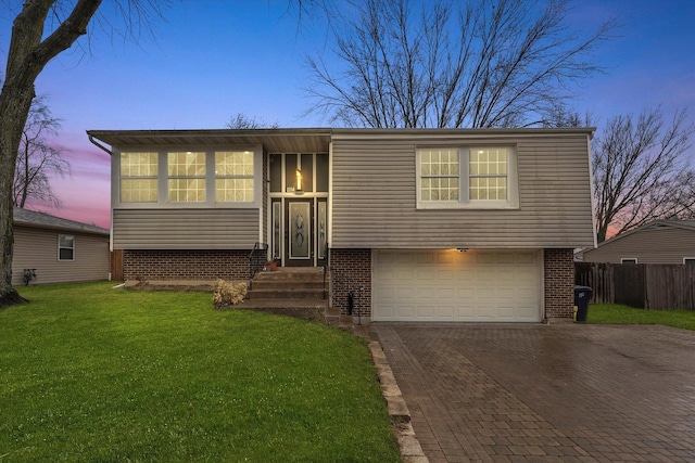 view of front of house featuring a yard and a garage