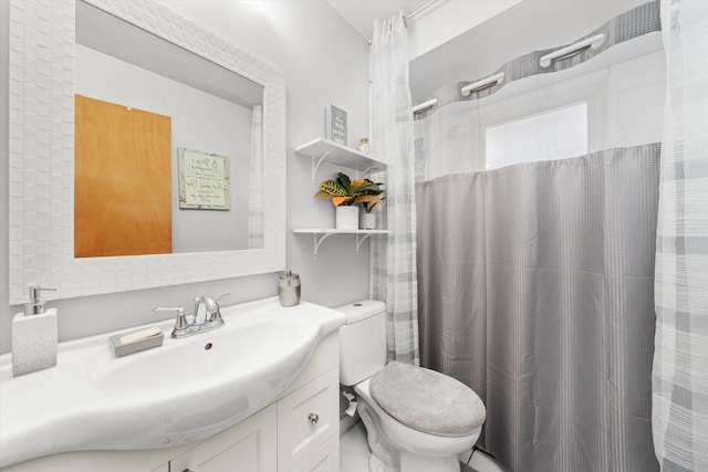 bathroom featuring vanity, a shower with shower curtain, and toilet