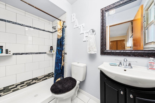 bathroom with tile patterned flooring, vanity, toilet, and walk in shower