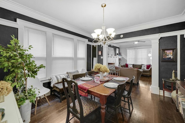 dining area featuring ornate columns, an inviting chandelier, dark hardwood / wood-style floors, and ornamental molding