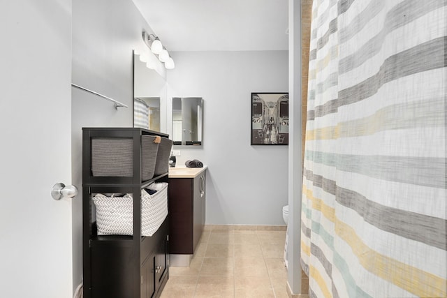 bathroom with vanity, toilet, and tile patterned floors