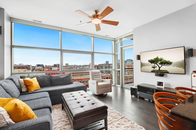 living room with hardwood / wood-style floors, a wall of windows, and ceiling fan