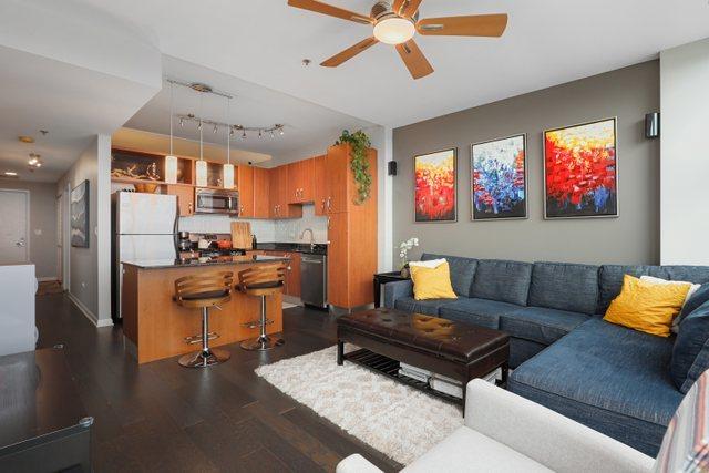 living room with ceiling fan, dark wood-type flooring, and sink