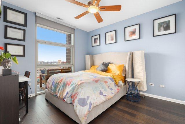 bedroom with ceiling fan and dark hardwood / wood-style flooring