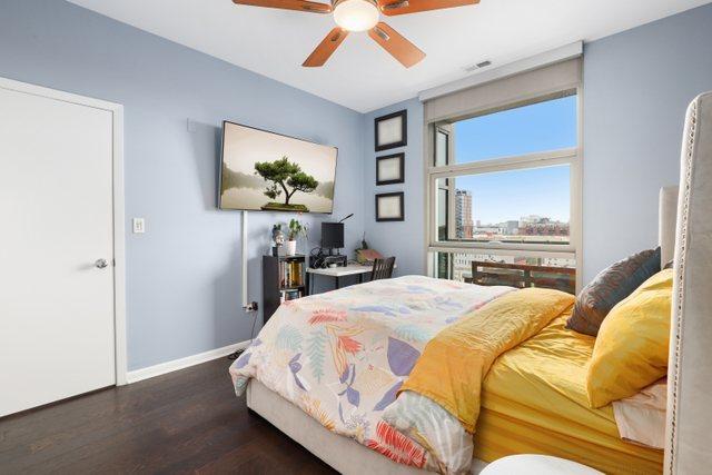 bedroom featuring ceiling fan and dark hardwood / wood-style floors