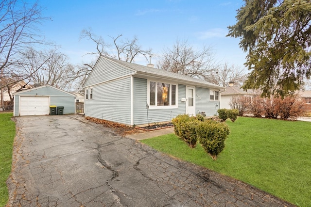 ranch-style home featuring a garage, an outbuilding, and a front lawn