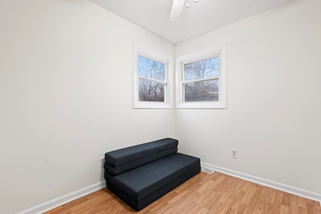 sitting room with light hardwood / wood-style floors and ceiling fan