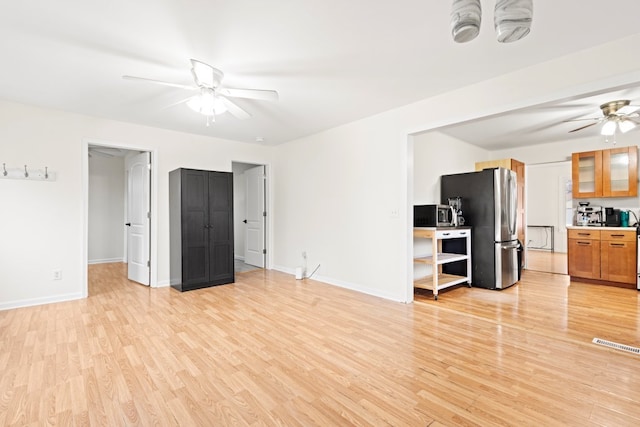 unfurnished living room with ceiling fan and light hardwood / wood-style floors