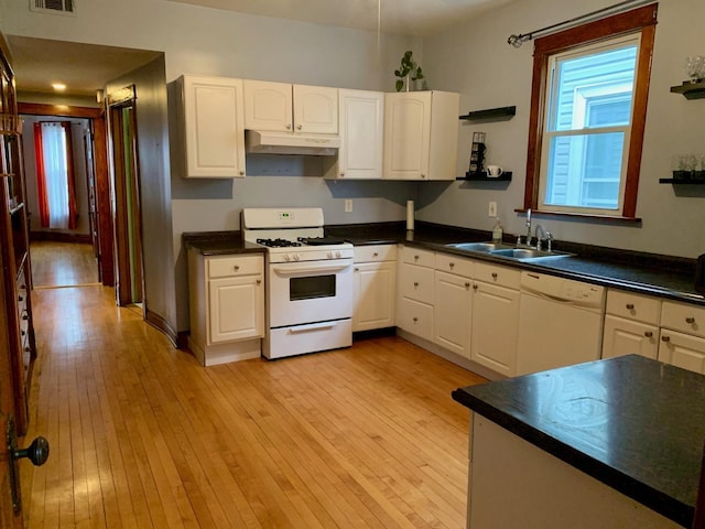 kitchen with white appliances, light hardwood / wood-style floors, white cabinetry, and sink