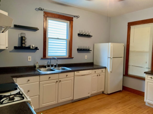 kitchen featuring white cabinetry, sink, and white appliances