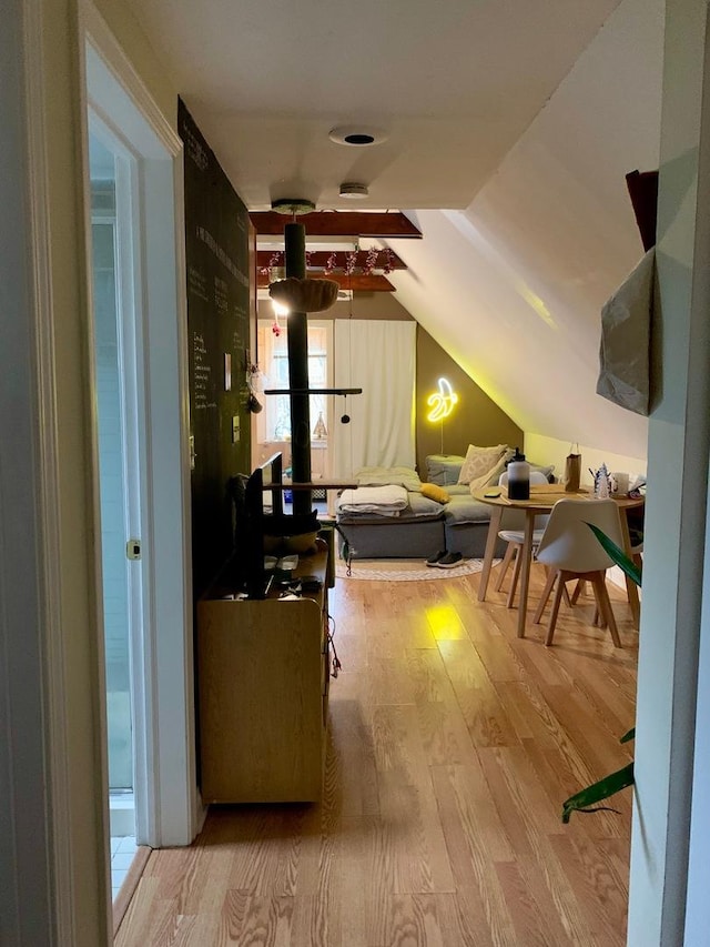 interior space with light hardwood / wood-style floors and vaulted ceiling