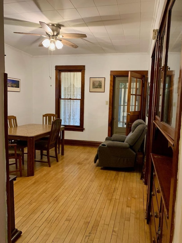 interior space featuring light hardwood / wood-style flooring, ceiling fan, and crown molding