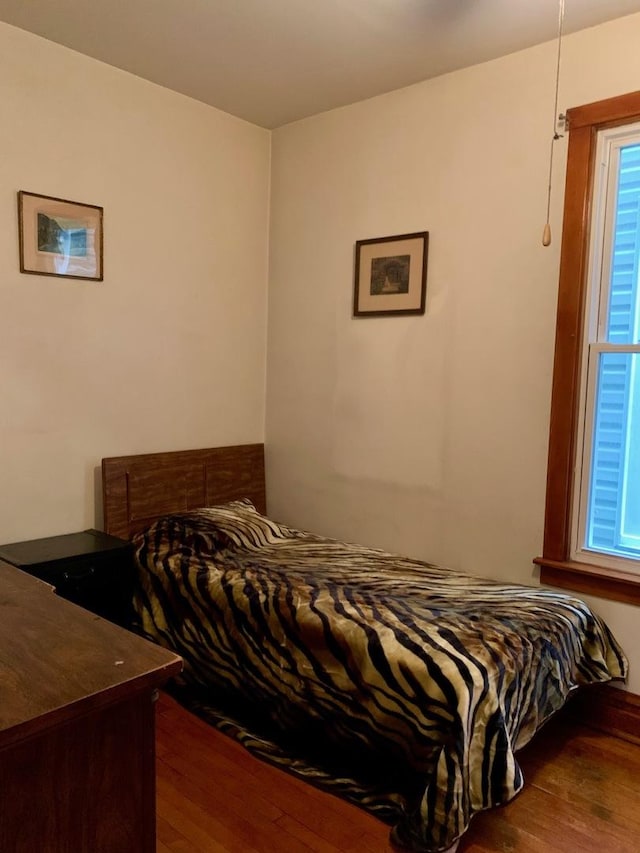 bedroom with hardwood / wood-style flooring