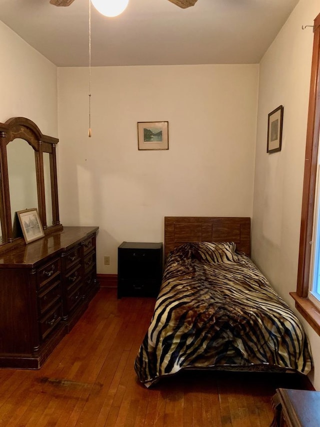 bedroom with dark hardwood / wood-style floors and ceiling fan